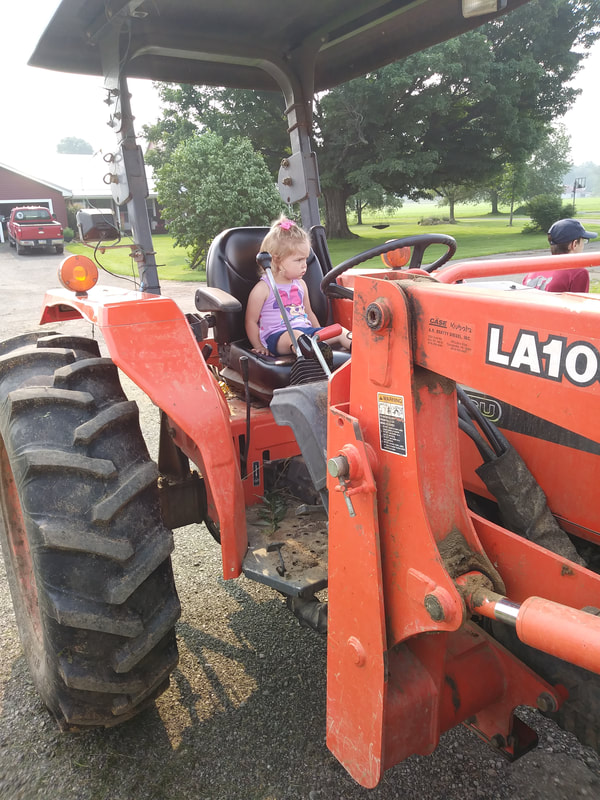 2021 Farm Week VanOrd Farm Visit girl on tractor
